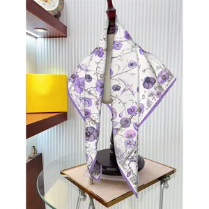 Elegant 90cm square silk scarf with purple floral and bird print on a mannequin