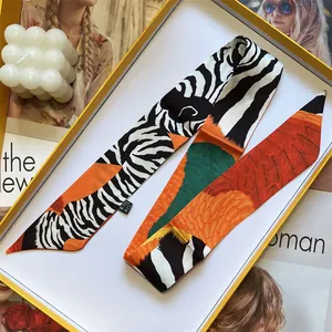 Elegant zebra and leaf print silk twilly scarf in a minimalist yellow gift box