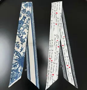 Detail of floral bird patterns and 'Je vous adore' text on 100% polyester silk scarves