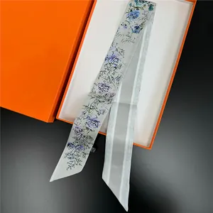 Double-sided floral silk twilly scarf with blue roses in iconic orange gift box