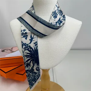 Detailed blue and white Toile de Jouy silk twilly scarf styled on a white mannequin