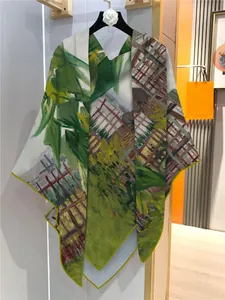 Detail of artistic oil painting scarf with yellow edge hanging on a clothing rack