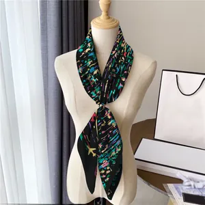 Black silk texture scarf with colorful abstract splash patterns on a white mannequin
