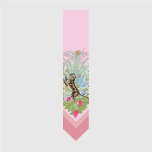 Detail of pink silk twilly scarf featuring a tropical tiger and floral jungle pattern