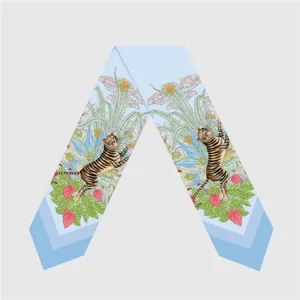 Detail of light blue silk twilly featuring exotic tiger and tropical floral illustrations