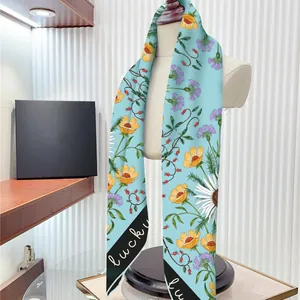 Light blue floral silk scarf with lucky lettering on an elegant display mannequin