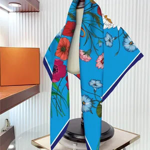 Royal blue floral silk scarf top with vivid poppy print displayed on a mannequin