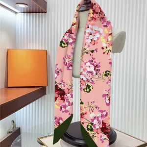 Pink satin floral silk scarf featuring elegant orchid patterns with green border detail
