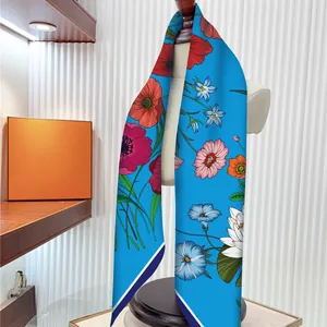 Blue silk scarf with floral prints and diagonal stripes displayed on a white mannequin