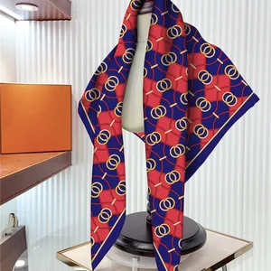Elegant silk scarf with red, blue, and yellow geometric chain patterns on white mannequin