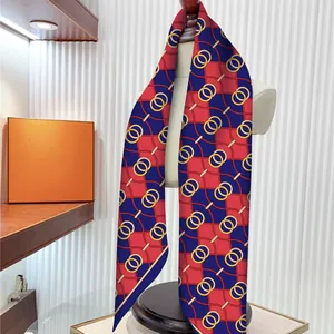 Elegant red and blue square scarf with gold chain print on a mannequin