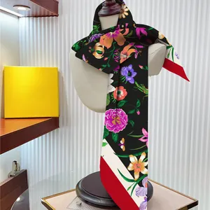 Floral silk scarf with colorful botanical prints and red-white contrast border detail