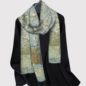 Artistic Van Gogh almond blossom style long silk scarf draped on a black cardigan