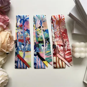 Detail of three narrow twilly scarves featuring jungle prints and floral patterns
