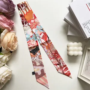 Detail of dog print silk scarf twilly featuring artistic floral and puppy illustrations