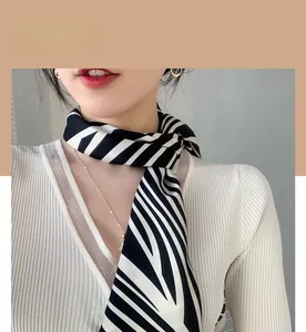 Close-up of zebra stripe satin scarf tied elegantly on a model with white V-neck top