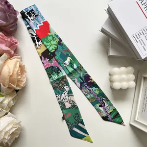 Detail of green silk scarf twilly with pet dog prints and floral decorative patterns