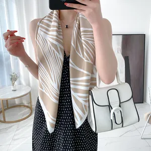 Elegant beige and white abstract striped satin scarf styled on a chic outfit