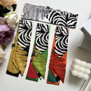 Detailed close-up of colorful floral and zebra print narrow twilly silk scarves set