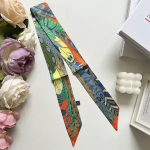 Detail of colorful feather print twilly silk scarf with pointed ends on white background