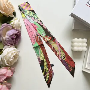 Detail of colorful feather print twilly scarf with 100% polyester care label