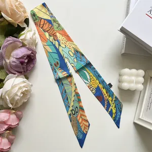 Detail of colorful long skinny silk scarf with abstract feather print and slanted edges