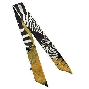 Elegant silk twilly scarf with zebra print and golden feather patterns on white background
