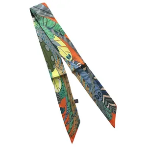 Vibrant orange twilly silk scarf with abstract feather patterns for hair and bags