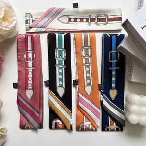 Flat lay of five elegant silk-like narrow scarves with retro buckle and stripe patterns