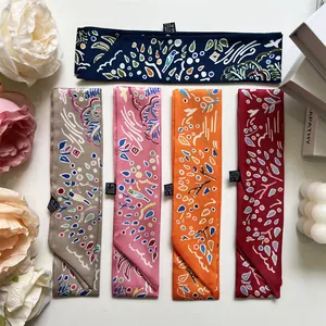 Flat lay of five patterned polyester twilly scarves in pink and navy for hair decoration