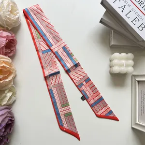 Detailed view of long twilly silk scarf with colorful geometric patterns and fabric tag