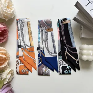 Detailed macro view of three narrow polyester twilly scarves with elegant chain and rope patterns