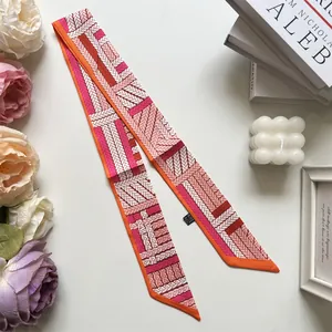Detailed close-up of patterned silk twilly scarf with elegant weave and wash label