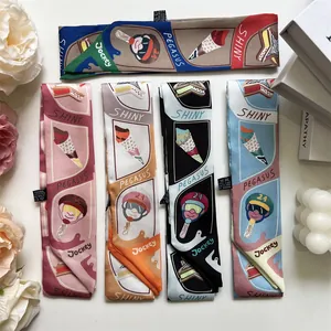 Detail showing various silk twilly scarves with horse and ice cream patterns on white decor