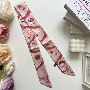 Close-up of pink silk scarf with ice cream and zebra motifs for luxury handbags