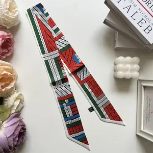 Detail of elegant printed twilly silk scarf with vintage knit pattern and laundry tag