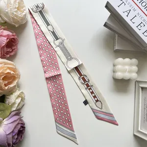 Close-up of pink polka dot silk scarf with vintage belt patterns and elegant roses