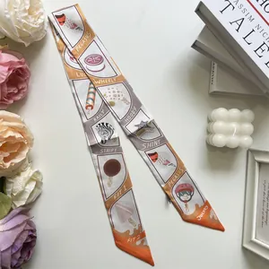 Close-up of a white and orange silk Twilly ribbon featuring zebra and Pegasus illustrations
