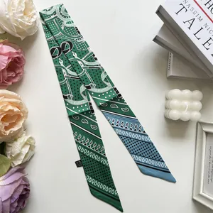 Detailed shot of forest green silk scarf with equestrian chain print and floral patterns