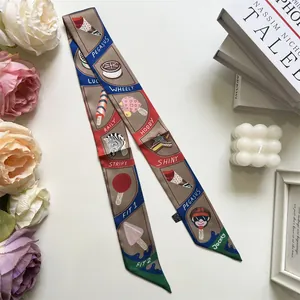 Close-up of a brown silk skinny scarf with playful ice cream and zebra motifs