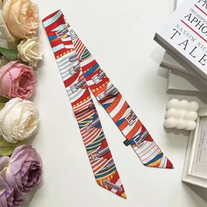 Detail of a striped narrow twilly scarf with belt buckle print and floral background