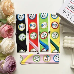 Flat lay of colorful narrow scarves with heart patterns and storybook illustrations