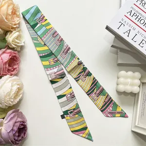 Close-up of a striped silk Twilly scarf with French floral patterns and a sleek texture