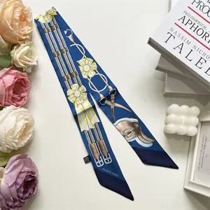 Detail of royal blue silk scarf with equestrian print and yellow floral patterns