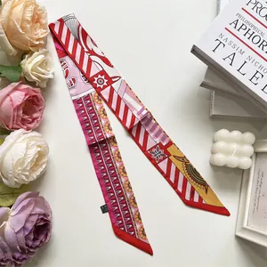 Detail of red and yellow patterned silk twilly scarf with PARIS text and wash label