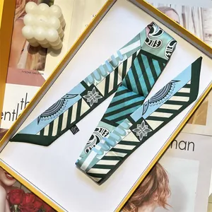 Elegant geometric patterned blue and green twilly silk scarf in a stylish white gift box