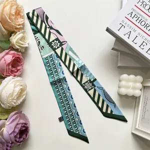 Detailed macro view of a patterned satin twilly scarf with geometric floral designs