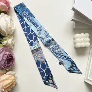Detailed view of silk-like neck scarf with giraffe print and floral patterns