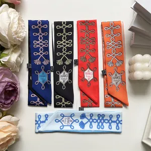 Detailed flat lay of nautical pattern twilly scarves in multiple colors with elegant props