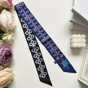 Detail of elegant French style silk scarves with knot patterns and France Paris text print